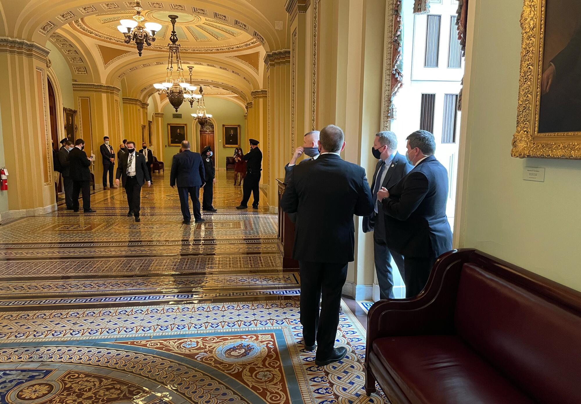 Former Vice President Mike Pence's Secret Service detail speak in a Capitol hallway