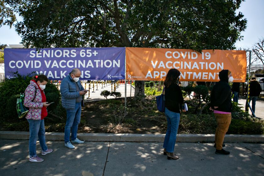 LOS ANGLELES, CA - MARCH 15: People wait outside of Kedren Community Health Center as vaccinations started today for those with disabilities on Monday, March 15, 2021 in Los Angeles, CA. (Jason Armond / Los Angeles Times)