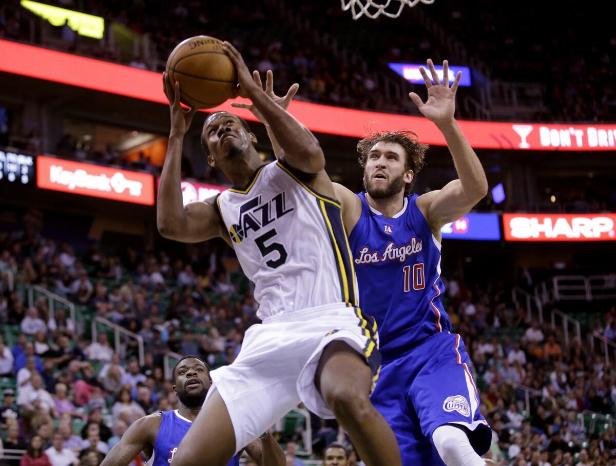 Utah Jazz's Rodney Hood drives to the basket in front of Clippers' Spencer Hawes on Monday night.