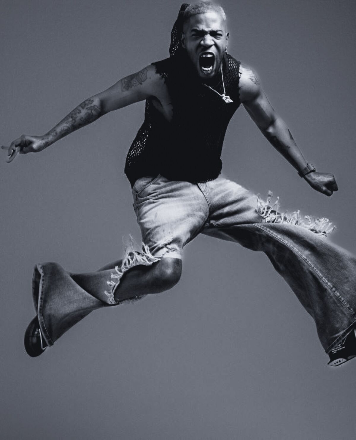 black and white photo of a man screaming while jumping