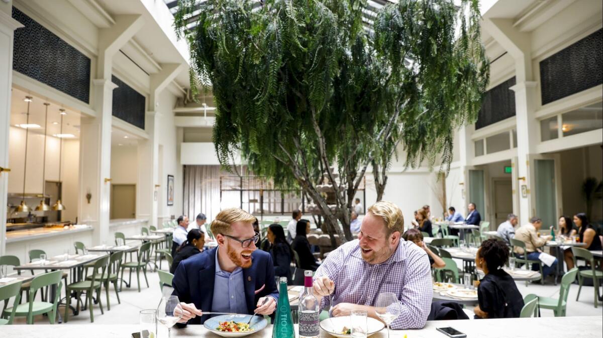 Dave Lofstrom, left and Nicolas Somers, enjoy lunch inside the downtown Los Angeles restaurant Spring.