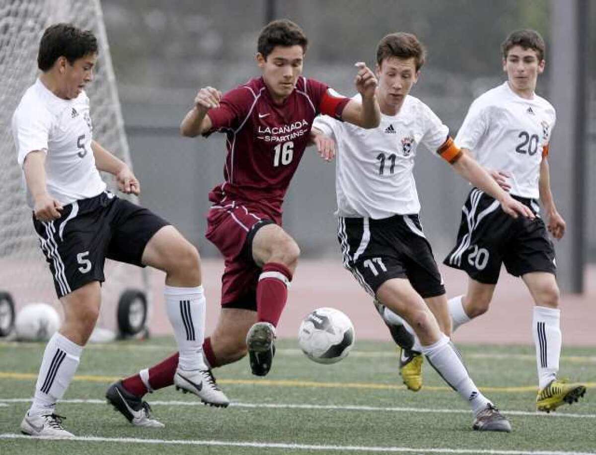 La Canada's Aidan Tourani, #16, battles for the ball with, from left, South Pasadena's Oscar Jaime, Charlie Slocum and Zack Dunn.