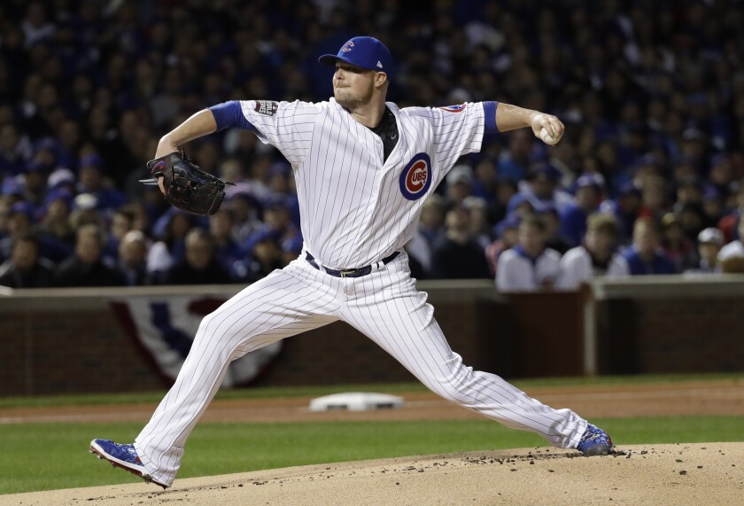 FILE - Chicago Cubs starting pitcher Jon Lester throws during the first inning of Game 5 of the Major League Baseball World Series against the Cleveland Indians on Sunday, Oct. 30, 2016, in Chicago. Lester, a durable left-hander who won three World Series titles during 16 years in the majors, has announced his retirement. Lester, who turned 38 on Friday, Jan. 7, 2022, finishes with a 200-117 record and a 3.66 ERA in 452 career games, including 451 starts. He also has been a reliable postseason performer, compiling a 2.51 ERA in 26 appearances.(AP Photo/David J. Phillip, File)