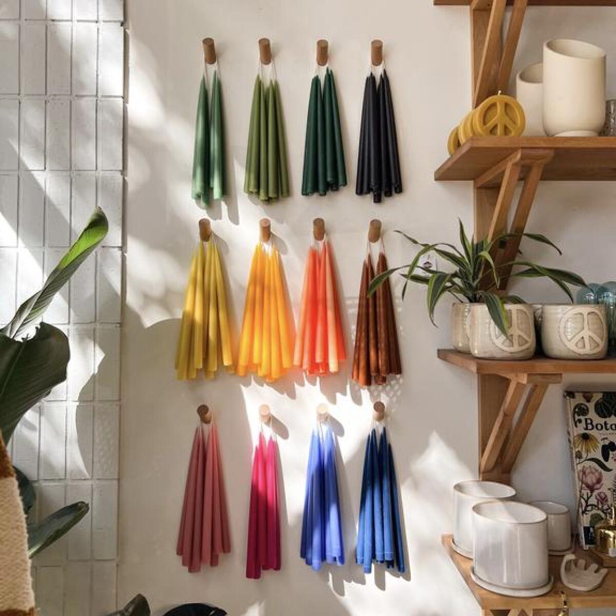 Handmade dripless beeswax taper candles in a rainbow of colors.