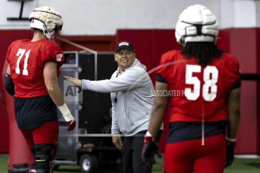Wisconsin offensive line coach AJ Blazek speaks to his players during NCAA college spring football practice at the McClain Center in Madison, Wis., Tuesday, April 9, 2024. (Samantha Madar/Wisconsin State Journal via AP)