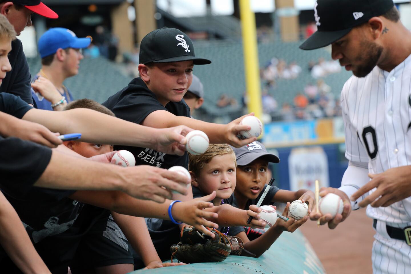 White Sox second baseman Yoan Moncada signs balls for young fans before the start of a game against the Yankees at Guaranteed Rate Field on Tuesday Aug. 7, 2018.