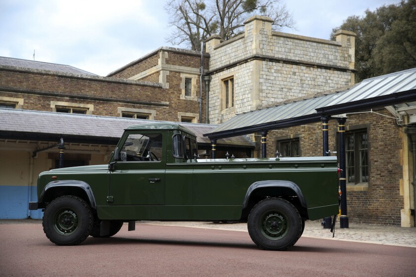 The Jaguar Land Rover that will be used to transport the coffin of the Duke of Edinburgh at his funeral on Saturday, is pictured at Windsor Castle, in Berkshire, England, Wednesday, April 14, 2021. The modified Land Rover Defender TD5 130 chassis cab vehicle was made at Land Rover's factory in Solihull in 2003 and Philip oversaw the modifications throughout the intervening years, requesting a repaint in military green and designing the open top rear and special "stops" to secure his coffin in place. (Steve Parsons/Pool Photo via AP)