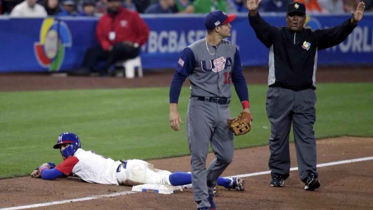 Puerto Rico infielder Javier Baez is called safe by umpire Edgar Estivision after stealing third base as United States' infielder Nolan Arenado looks on during the sixth inning of a World Baseball Classic game on March 17.