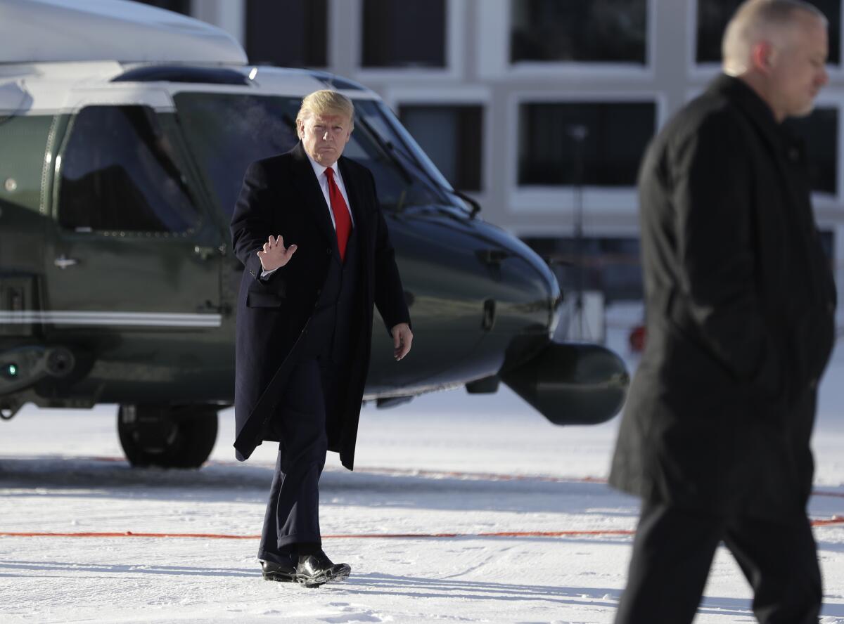 President Trump waves as he arrives in Davos on Marine One on Tuesday.