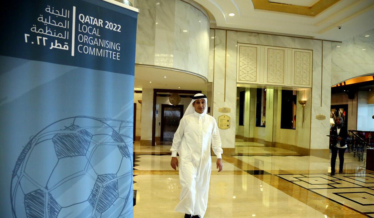 A man walks past the venue where FIFA officials met members of the Qatar 2022 local organizing committee in Doha, Qatar, to discuss matters relating to the rescheduling of the World Cup from summer to winter on Tuesday.