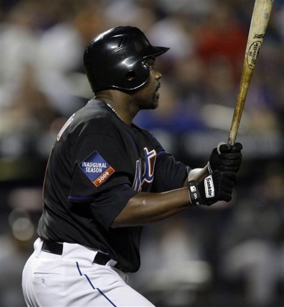New York Mets' Carlos Delgado watches his eighth inning three-run home run sail over the right field wall against the Pittsburgh Pirates during a baseball game Friday, May 8, 2009 at Citi Field in New York. (AP Photo/Julie Jacobson)