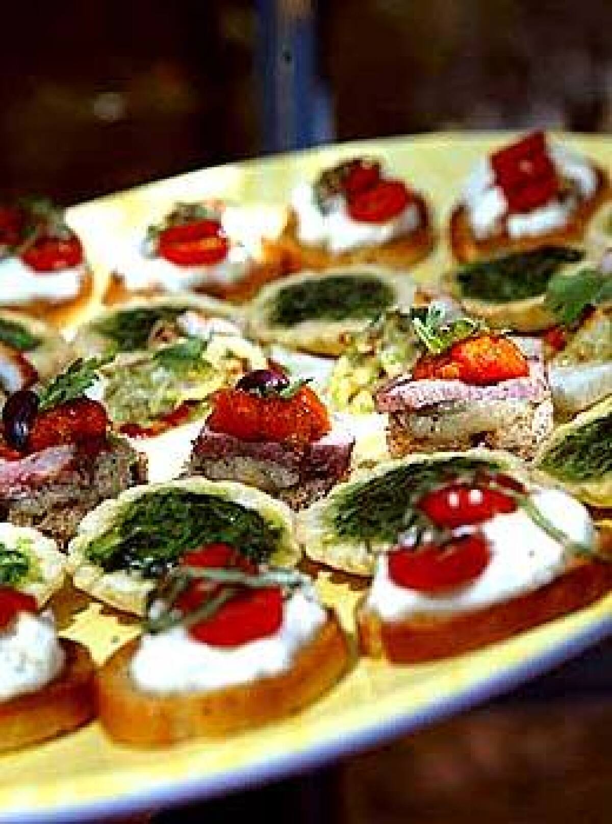 Latin, Asian and Mediterranean flavors come together on a tray of summer canapés. Caterers think of them as meal in one bite.