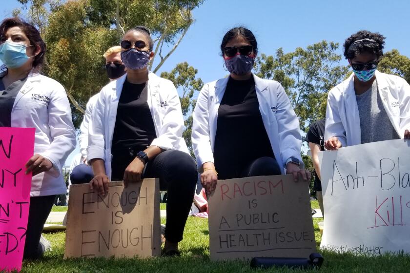 Scores of UC San Diego medical students and others rallied on the La Jolla campus Monday to speak out against racism.