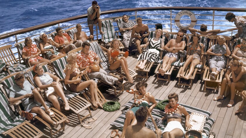 Guests aboard the S.S. Lurline in the early 1950s display the era's fashionable sun deck attire, which included coverups that women would wear over their swimsuits.