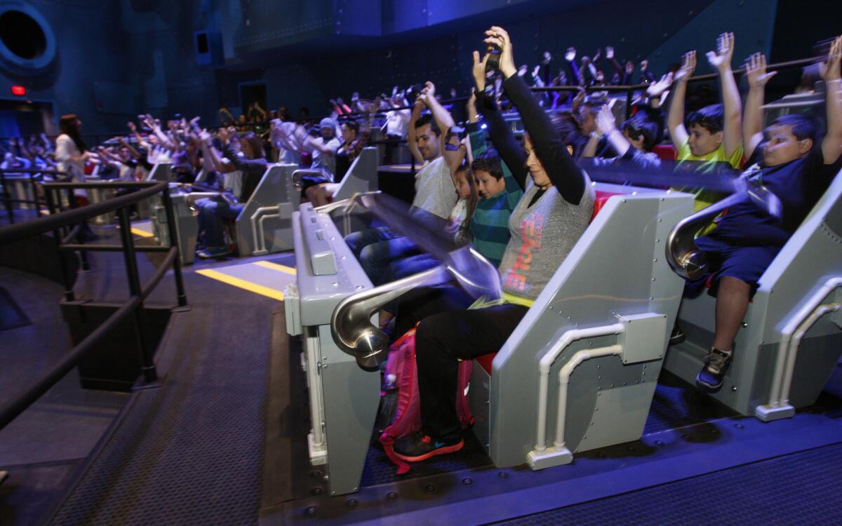Guests are fastened into their seats in Gru's laboratory as part of the new Minion Mayhem attraction at Universal Studios Hollywood.