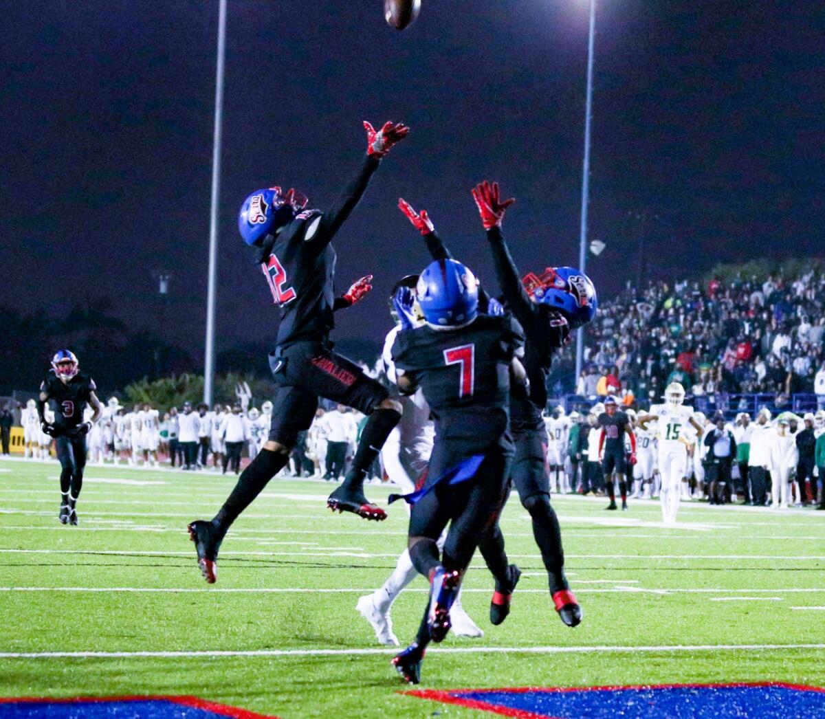 Gardena Serra secondary provides triple coverage against Long Beach Poly receiver.