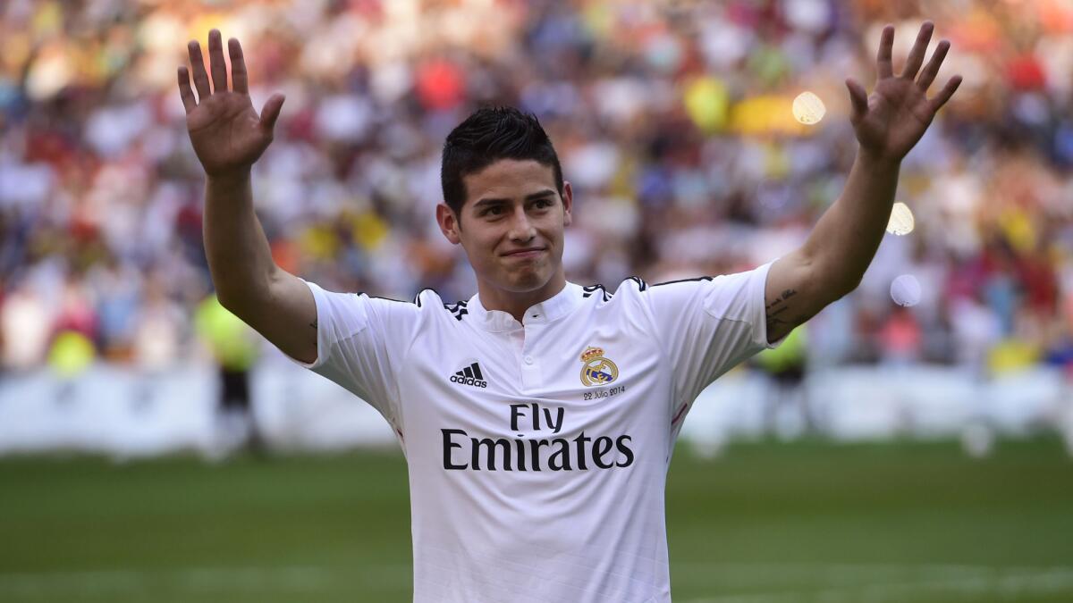Colombian striker James Rodriguez acknowledges the Real Madrid fans after signing with the Spanish club on July 22. Rodriguez is one of several high-profile soccer players who have signed with La Liga teams.