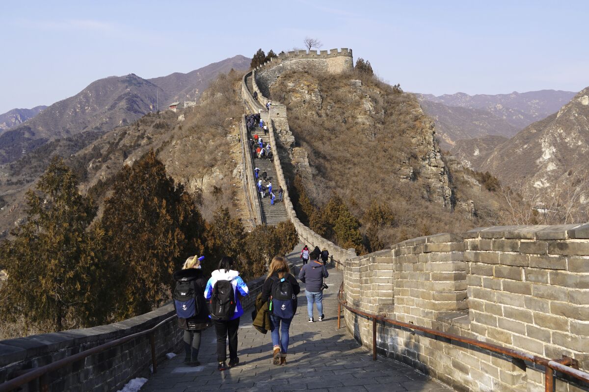A group of journalists covering the 2022 Winter Olympics, visit the Juyongguan section of the Great Wall the Wednesday, Feb. 9, 2022, on the outskirts of Beijing. (AP Photo/Chisato Tanaka)
