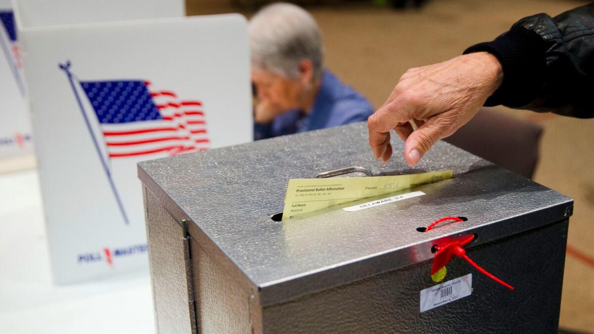 In this photo from March 2016, a primary election voter casts a provisional ballot in Westerville, Ohio. The Supreme Court is considering Ohio's plan to purge from its voter registration rolls people who go six years without voting.