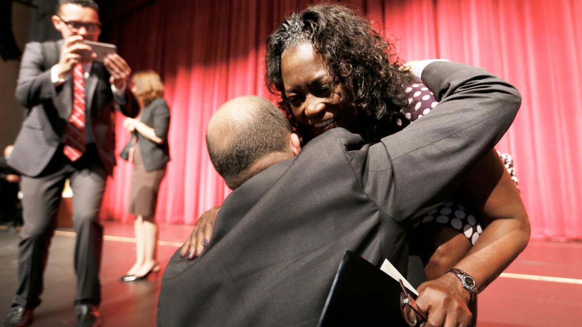 Supt. Michelle King and school board President Steve Zimmer hug after her state of the district address at Garfield High School in which she praised the class of 2016 s record graduation success.