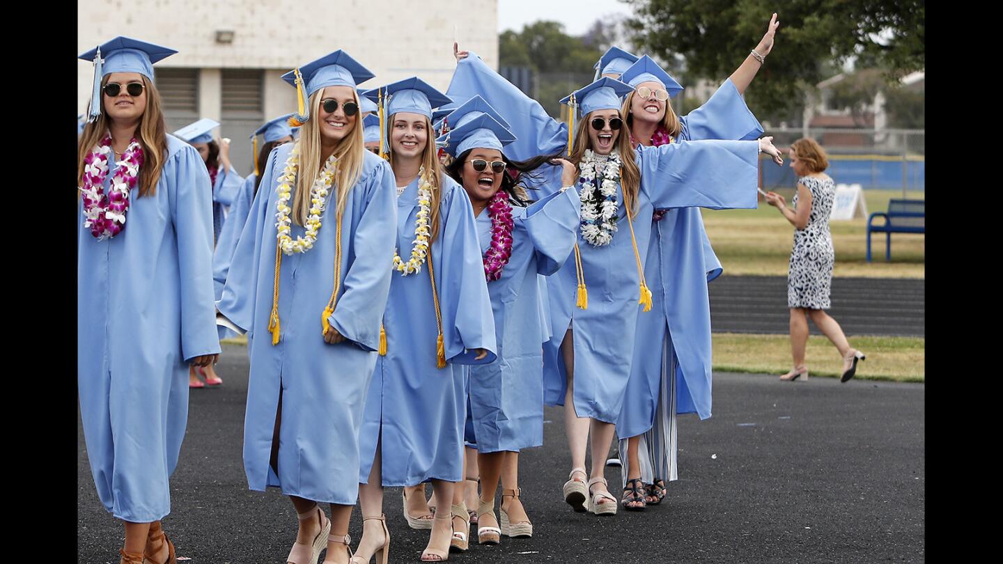 Graduates cheer during Corona del Mar High School's commencement ceremony in Newport Beach on Thursday.
