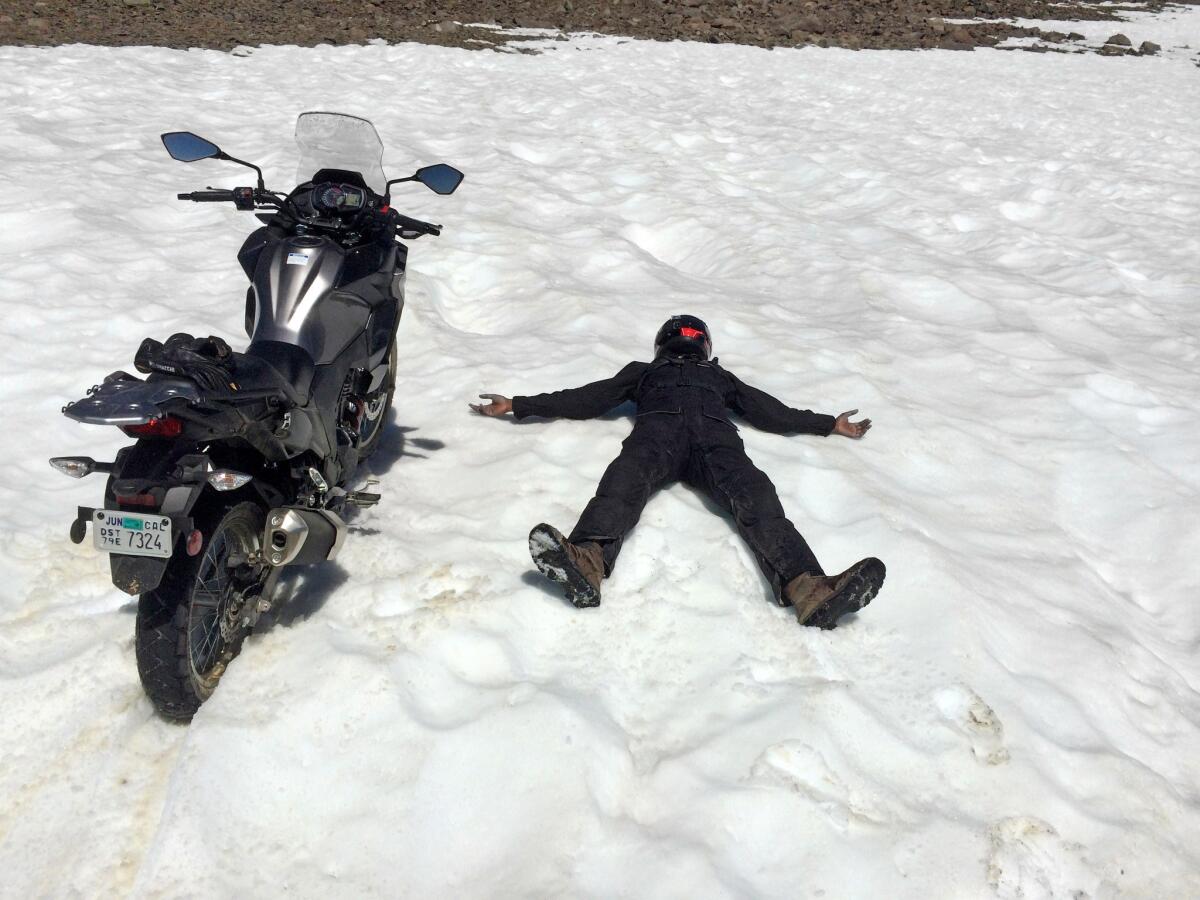 We didn't expect to see snow in July, even at 12,000 feet. Abhi expressed his enthusiasm by riding the Kawasaki directly into a drift, then lying down next to it.