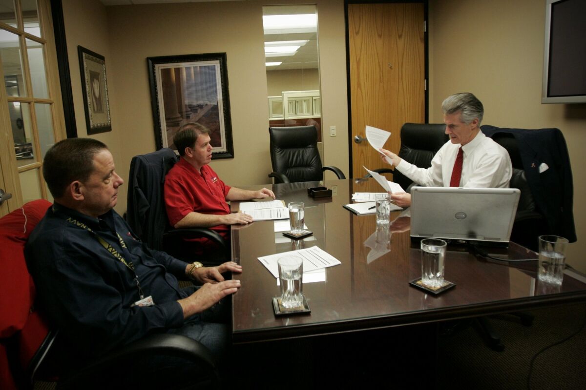 Jeff Harrington and Michael Mayer of Veteran Logistics meet with financial adviser R.J. Kelly, right, to discuss the formation of a charitable trust. — Nelvin C. Cepeda