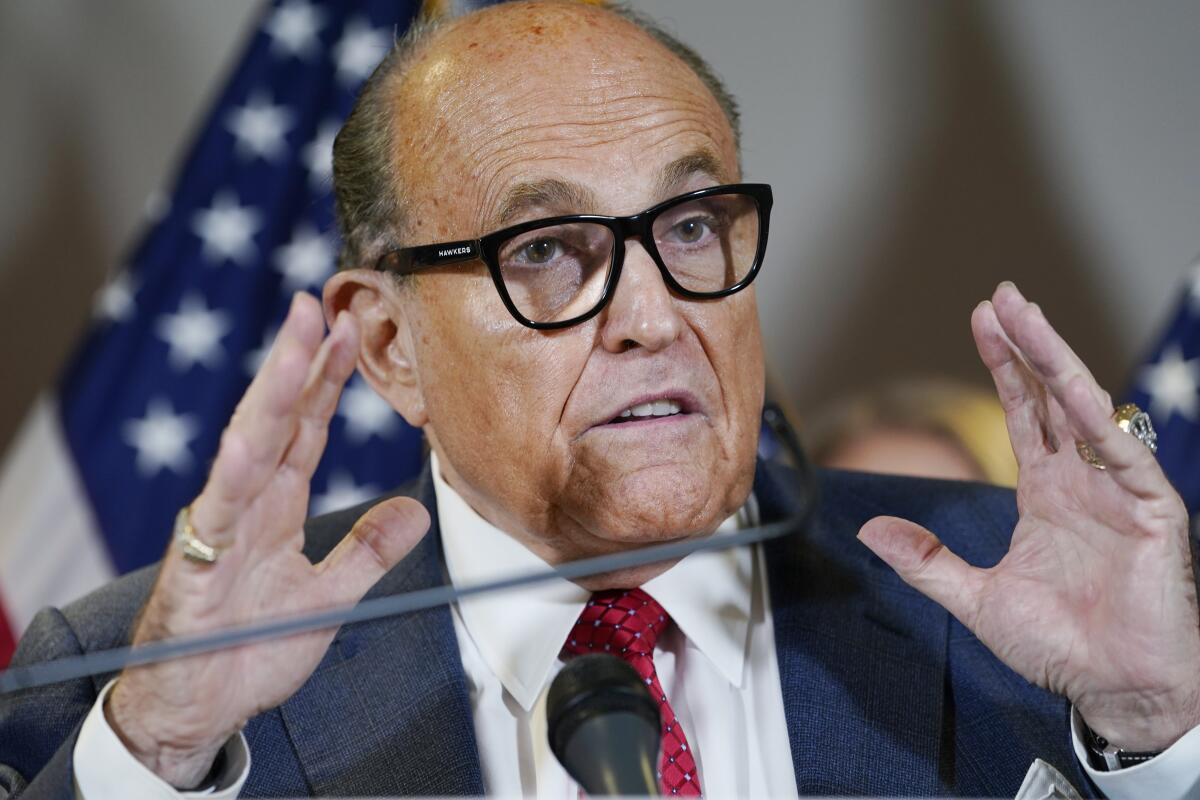 FILE - In this Nov. 19, 2020, file photo, former New York Mayor Rudy Giuliani speaks during a news conference at the Republican National Committee headquarters in Washington. Federal agents raided Giuliani’s Manhattan home and office on Wednesday, April 28, 2021, seizing computers and cellphones in a major escalation of the Justice Department’s investigation into the business dealings of former President Donald Trump’s personal lawyer. (AP Photo/Jacquelyn Martin, File)