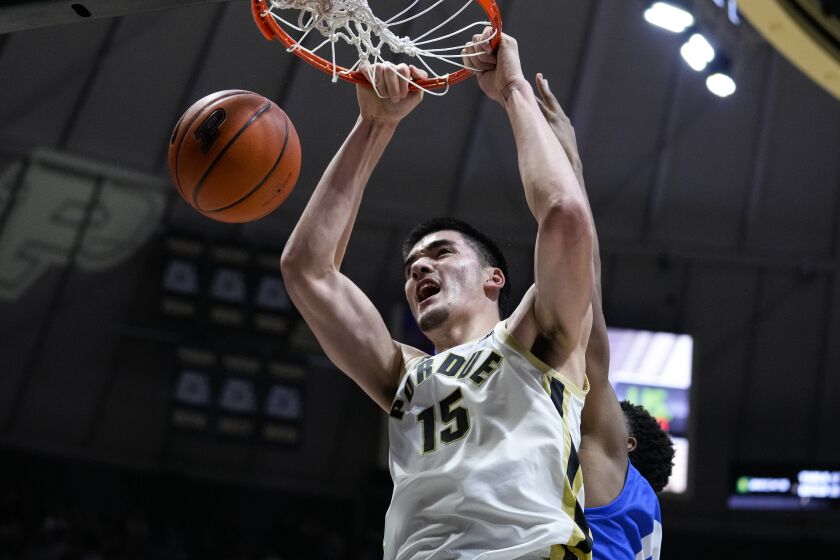 Purdue center Zach Edey (15) gets dunk in front of Hofstra forward Warren Williams (0) during the second half of an NCAA college basketball game in West Lafayette, Ind., Wednesday, Dec. 7, 2022. (AP Photo/Michael Conroy)