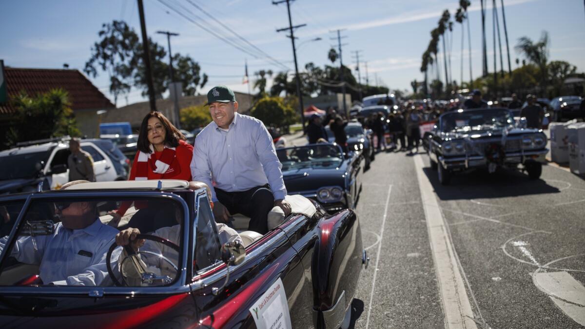 Alex Villanueva and his wife, Vivian, attend the East Los Angeles Christmas Parade in Los Angeles on Sunday, the day before he was sworn in as L.A. County sheriff.