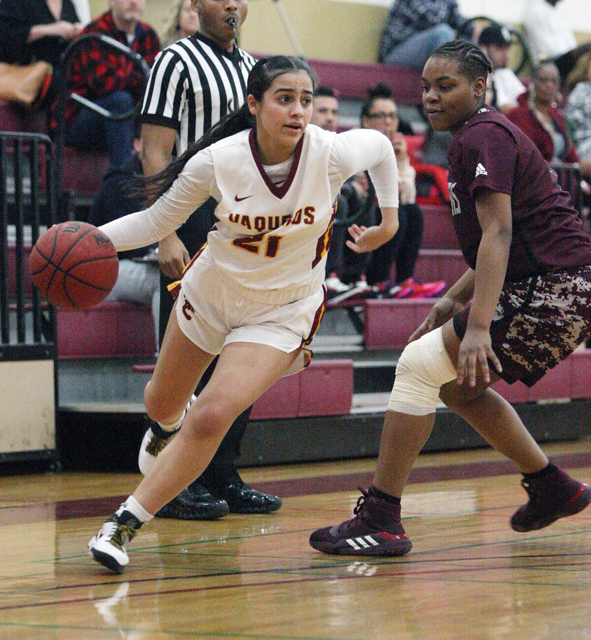Glendale Community College's Zoe Rouse cuts and dribbles around Antelope Valley's Niyah Page in a Western State Conference women's basketball game at Glendale Community College on Wednesday, January 22, 2020.