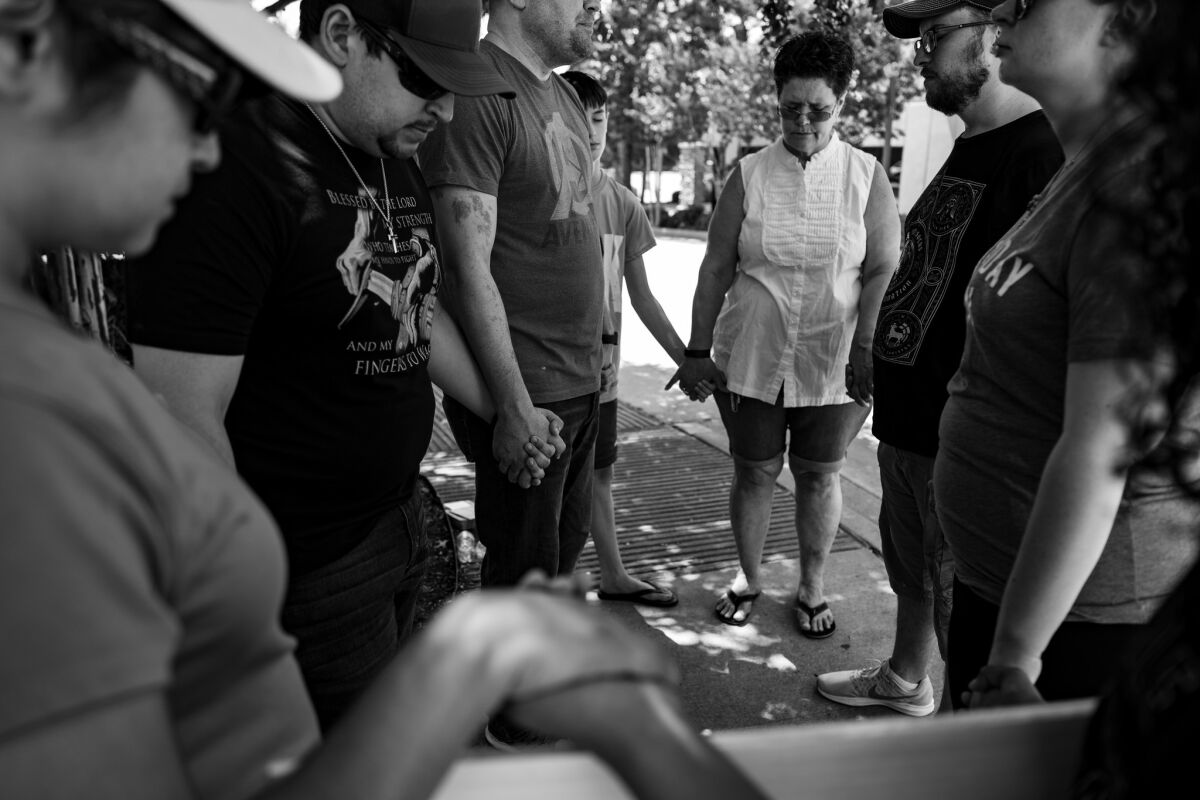 Antiabortion protesters hold hands in a circle to pray outside the clinic. (Gina Ferazzi / Los Angeles Times)