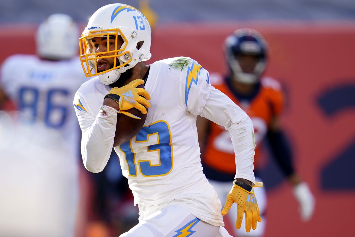 Los Angeles Chargers wide receiver Keenan Allen (13) scores a touchdown against the Denver Broncos during the first half of an NFL football game, Sunday, Nov. 1, 2020, in Denver. (AP Photo/David Zalubowski)