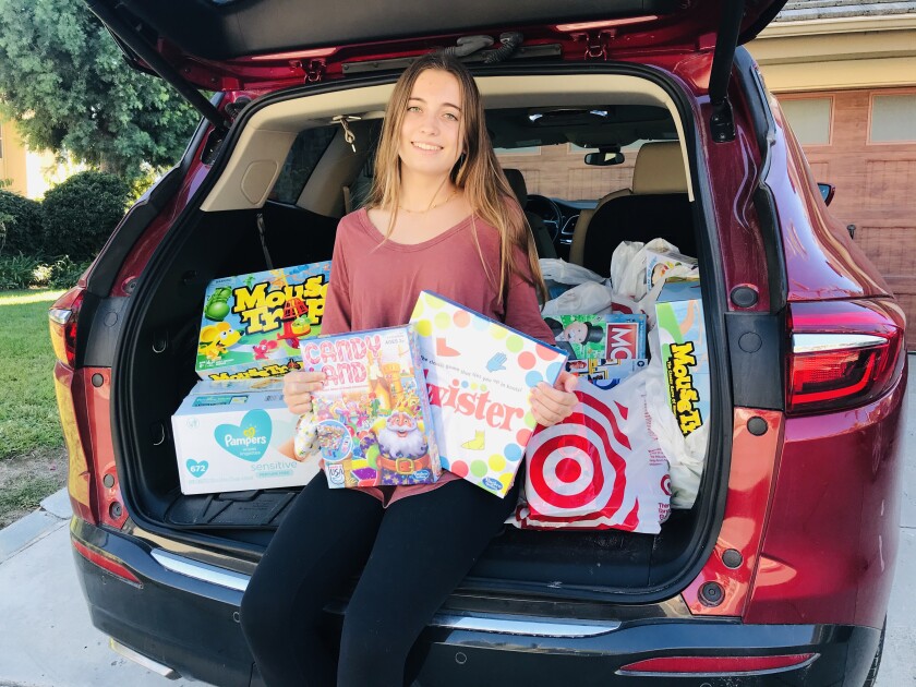 Lucie Babcock with donations for the Community Resource Center's 38th annual Holiday Baskets program.