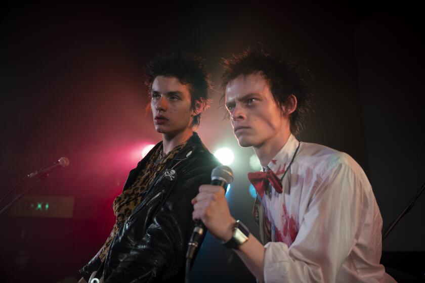 Two punk rockers at a mic on stage