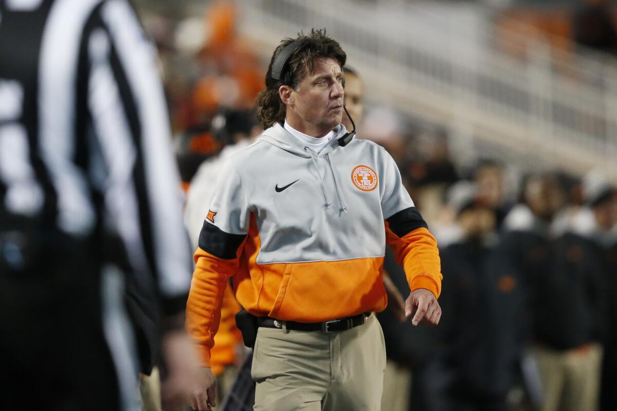 Oklahoma State coach Mike Gundy walks on the sideline during a game against Oklahoma on Nov. 30, 2019.