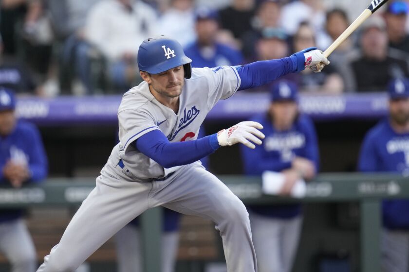 Los Angeles Dodgers' Trea Turner swings at a pitch from Colorado Rockies.