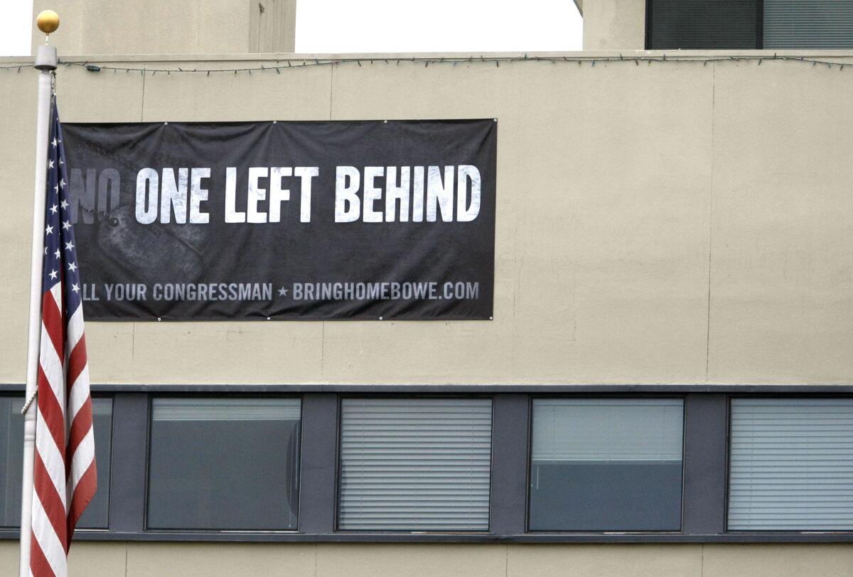 A banner with "No One Left Behind" is placed high above on the Allen Lund Co. building on Angeles Crest Highway in La Cañada Flintridge, shown on Tuesday, Nov. 12, 2013.