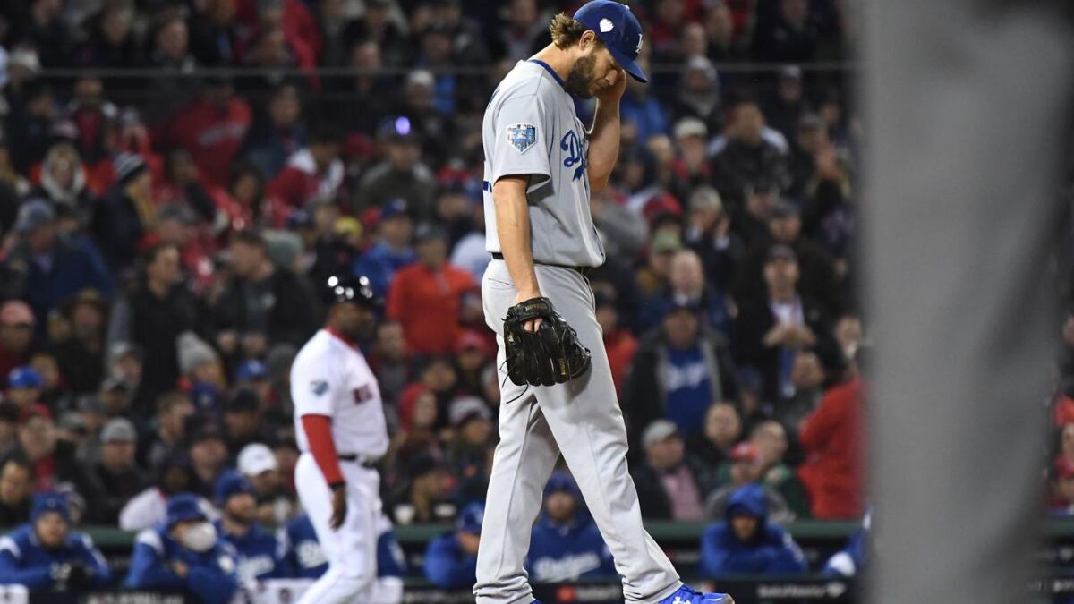 Dodgers pitcher Clayton Kershaw gives up a hit in the fifth inning of Game 1 of the World Series at Fenway Park on Tuesday in Boston.