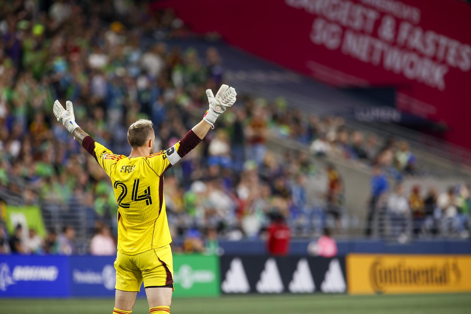 Sounders goalkeeper Stefan Frei holds his arms aloft in protest of a call on the field.