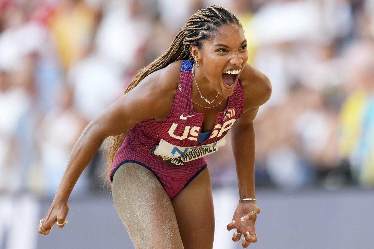 Tara Davis-Woodhall lets out a yell after winning the silver medal in women's long jump during the 2023 world championships.