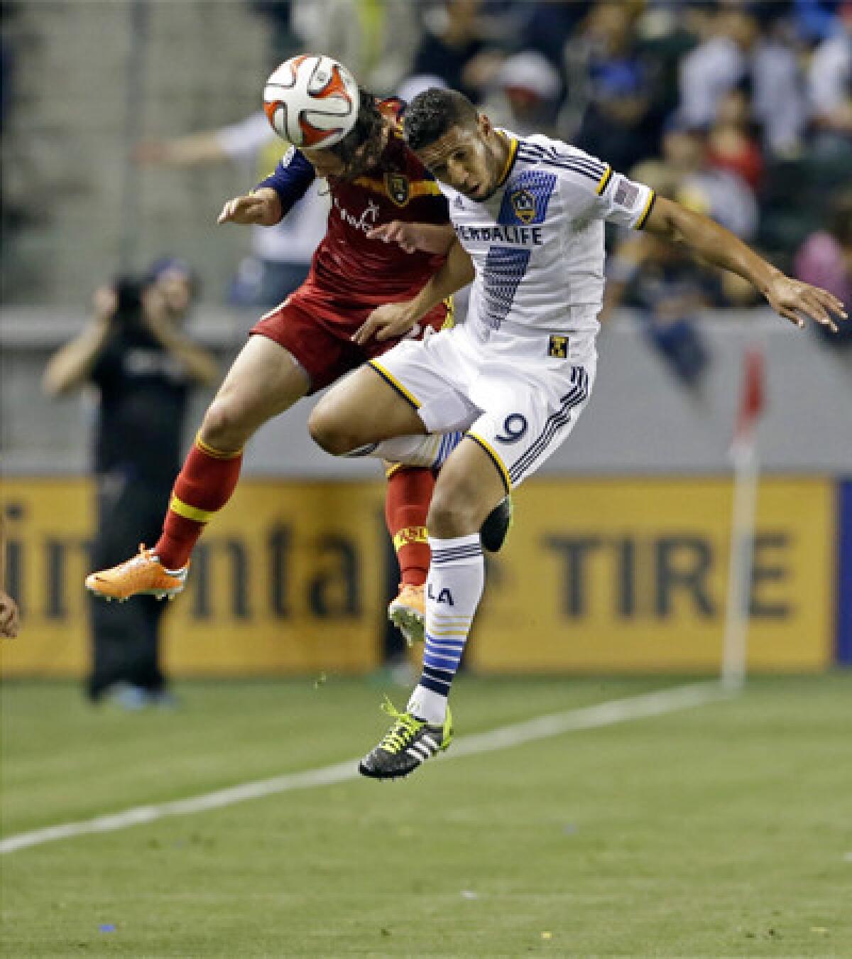 New Galaxy forward Samuel, right, goes for a header against Real Salt Lake midfielder Ned Grabavoy in Carson on Saturday night.