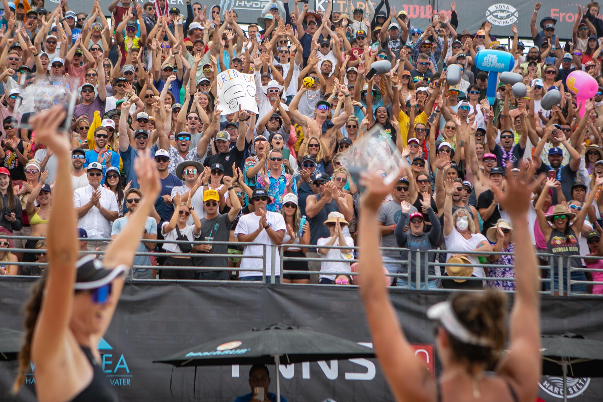 Terese Cannon and Sarah Sponcil raise their arms after winning the AVP Hermosa Beach Open.