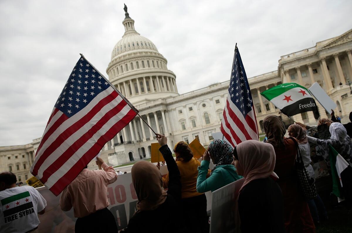 Syrian American protesters gather outside the U.S Capitol on Monday, urging Congress to support President Obama's call to strike Syria for using chemical weapons against its own people.