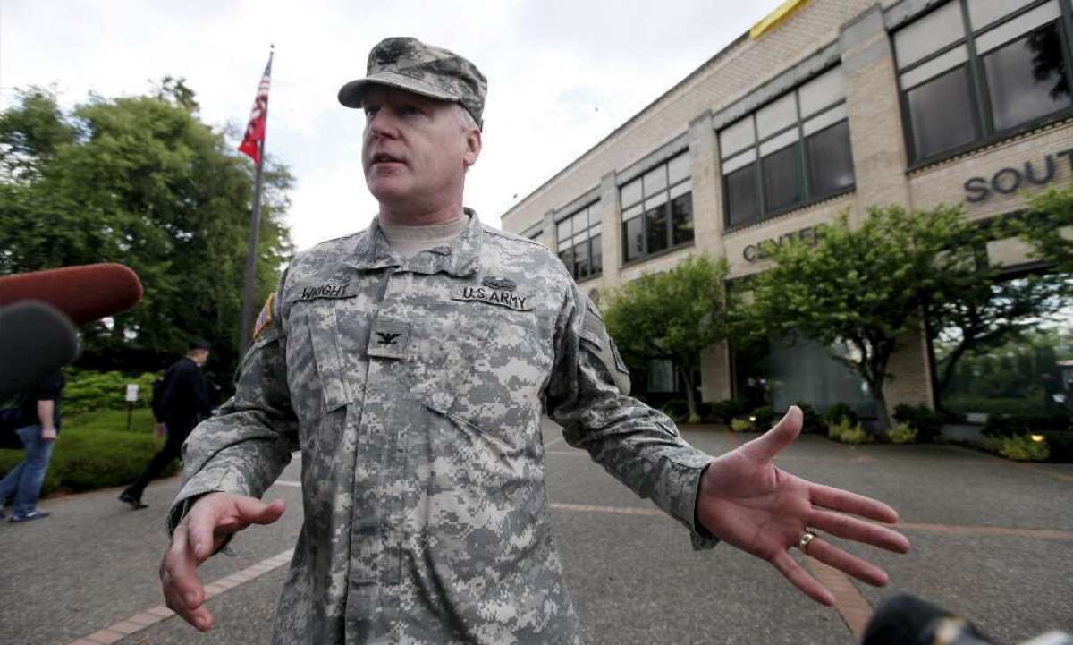Col. Anthony Wright speaks with media outside the Seattle Military Entrance Processing Center in this file photo. Two men have been sentenced in a plot to attack the center.