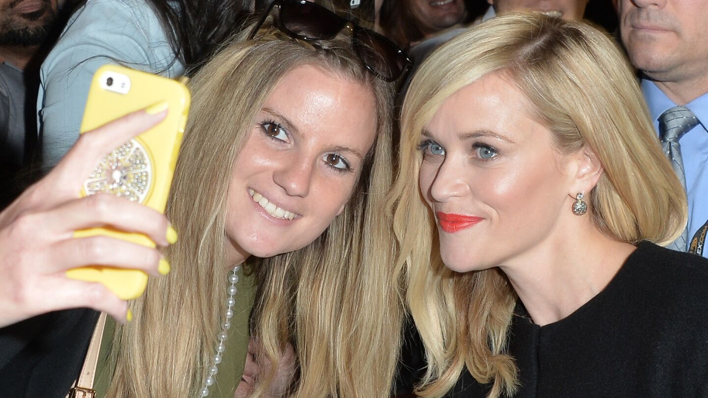 TORONTO, ON - SEPTEMBER 08: Actress Reese Witherspoon takes a selfie with a fan at the "Wild" premiere during the 2014 Toronto International Film Festival at Roy Thomson Hall on September 8, 2014 in Toronto, Canada.