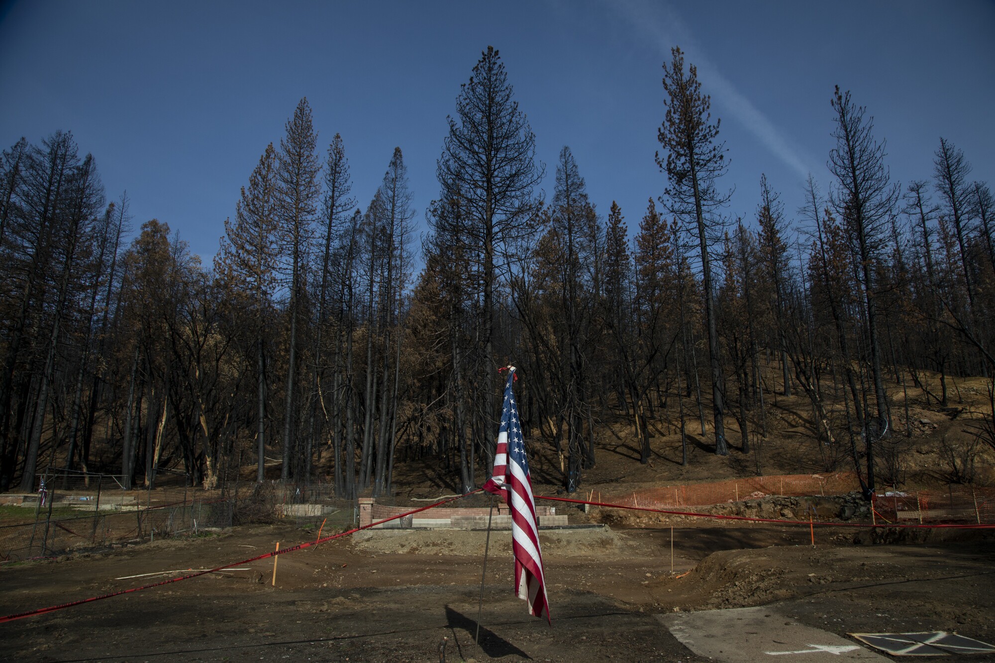 A U.S. flag on the site of a burned home.