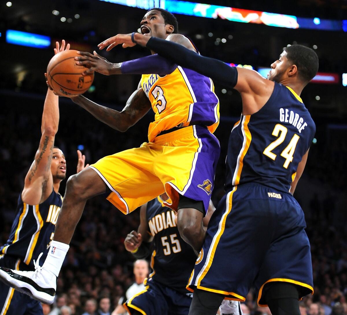 Lakers point guard Manny Harris drives to the basket in front of Indiana Pacers forward Paul George during the Lakers' 104-92 loss at Staples Center.