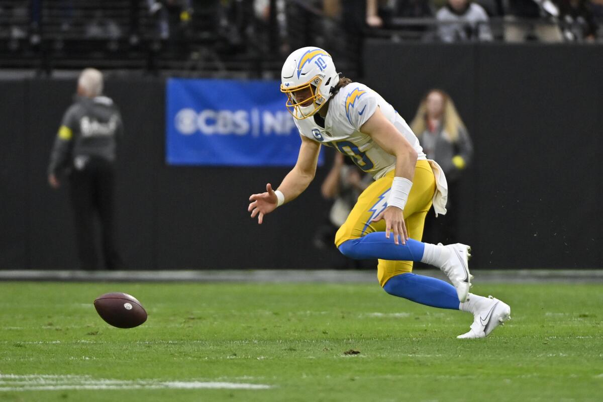 Chargers quarterback Justin Herbert (10) chases down his fumble during the first half  against the Raiders last week.