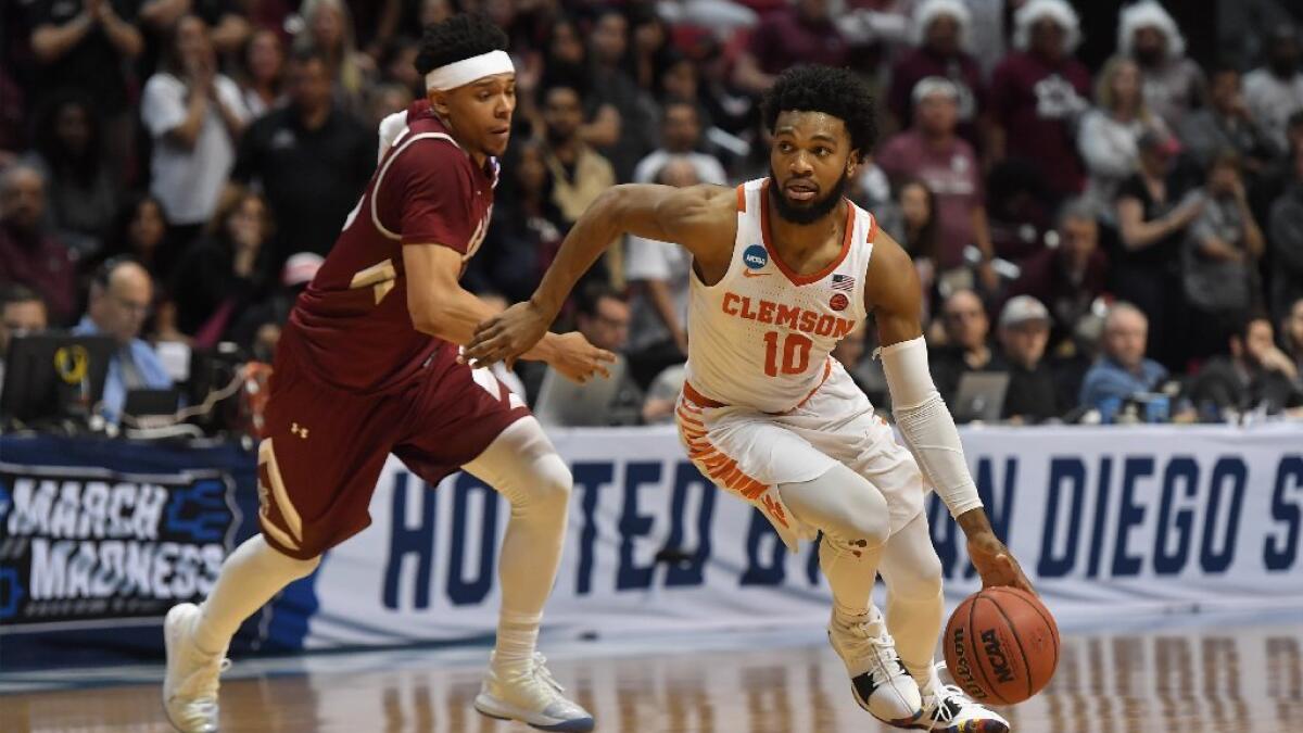 Clemson's K.J. McDaniels, left, steals a pass in the lane between